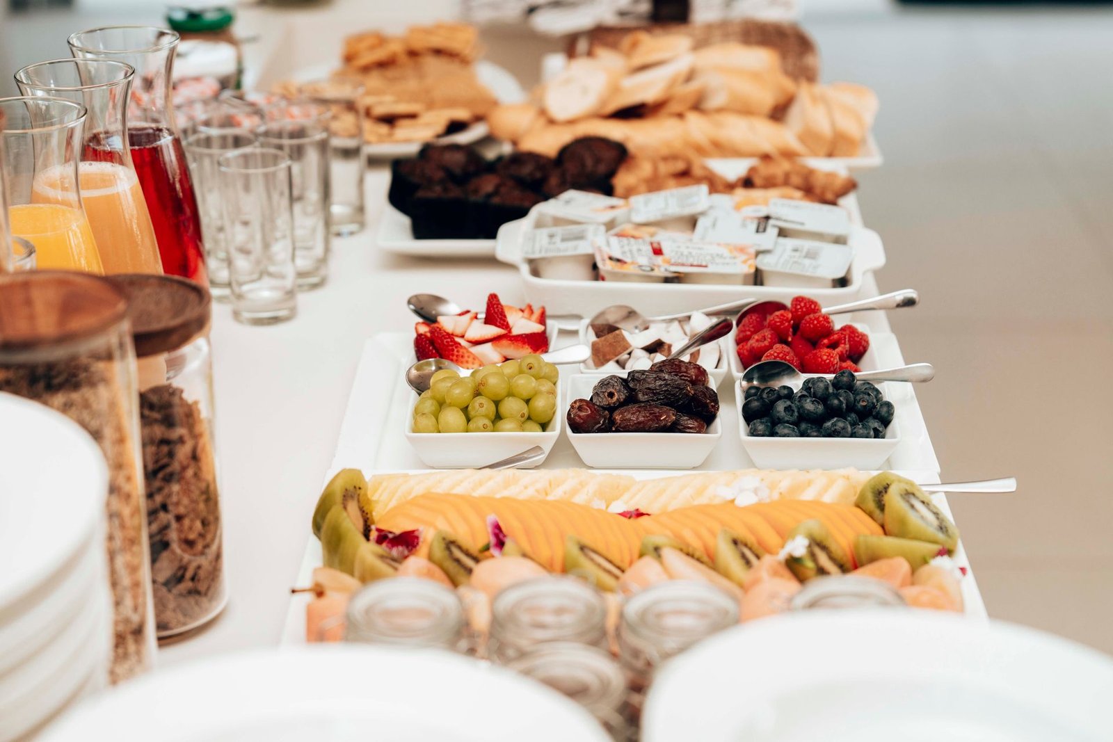 Mesa de café da manhã com frutas frescas, pães e sucos, exemplificando como o paladar e os sabores locais despertam memórias afetivas no turismo sinestésico.